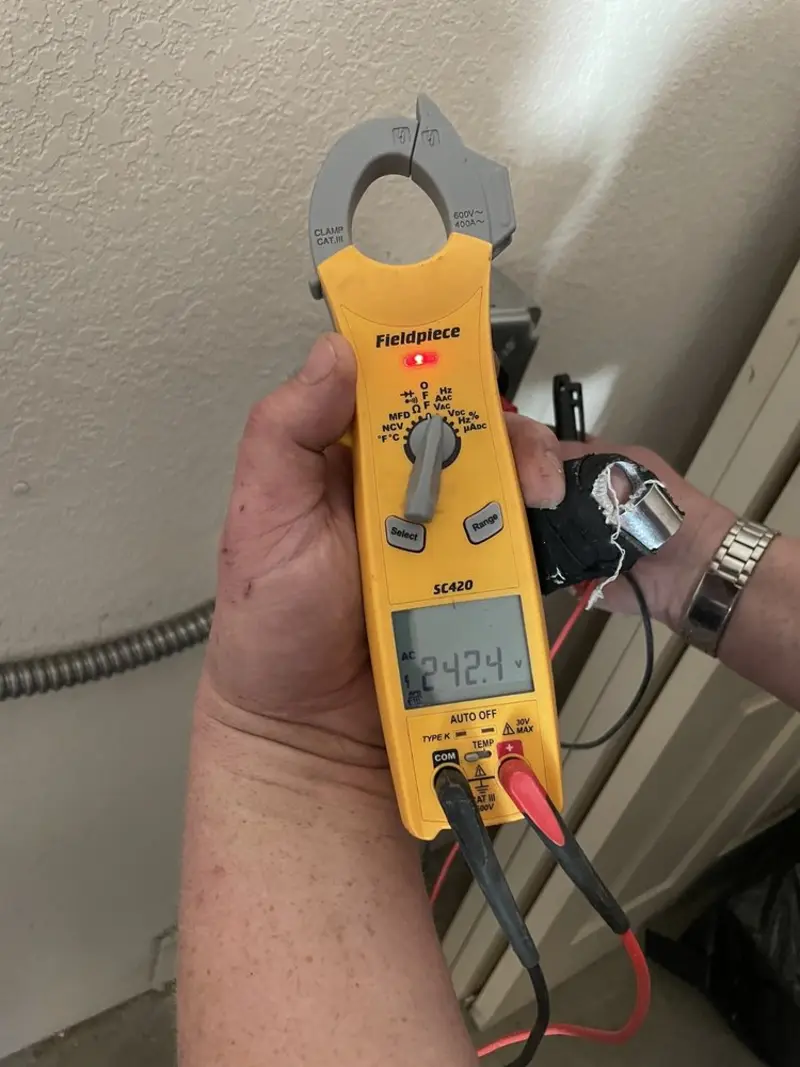 Voltage testing with clamp meter during Recessed Lighting Installation in D'Iberville